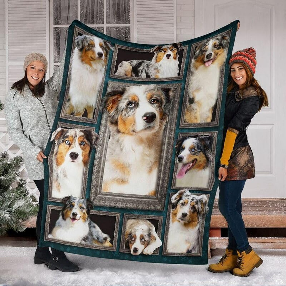 Two models displaying the Australian Shepherd blanket outside a snowy winter home entrance.