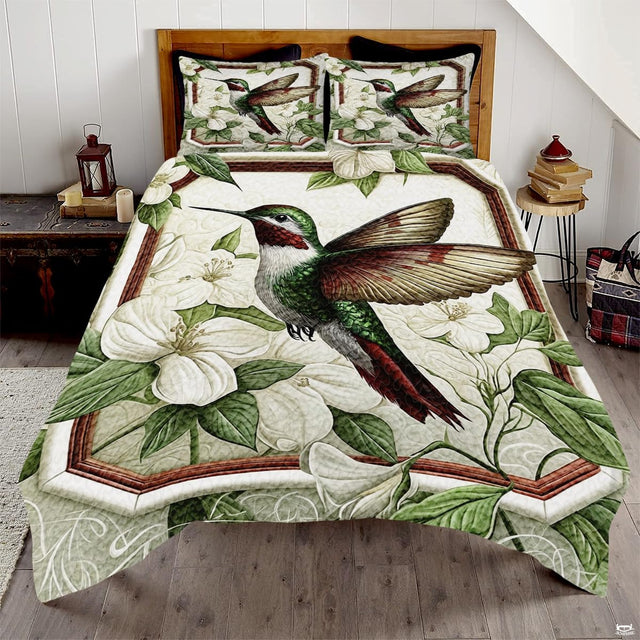Green hummingbird with burgundy throat among white blossoms in a brown frame