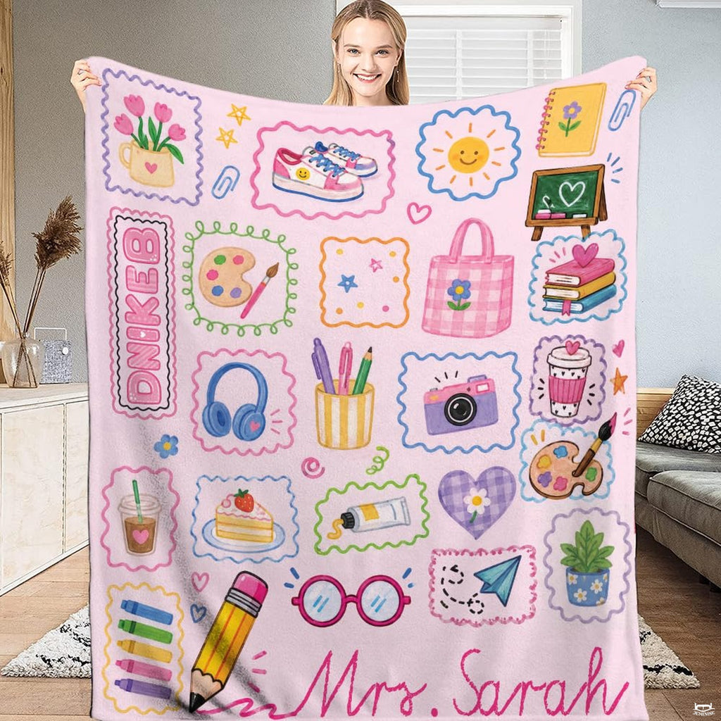Pastel pink teacher throw blanket featuring school doodles, art palette, and sticker collage