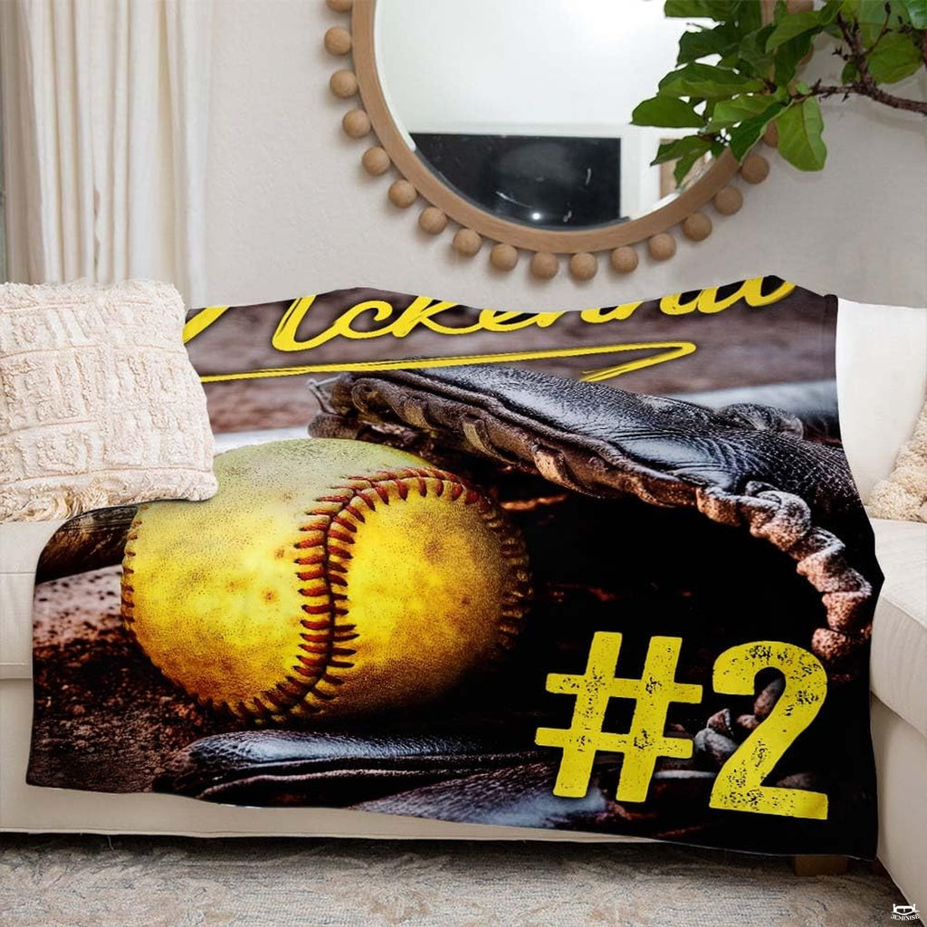 Fastpitch softball artwork blanket styled across couch sofa