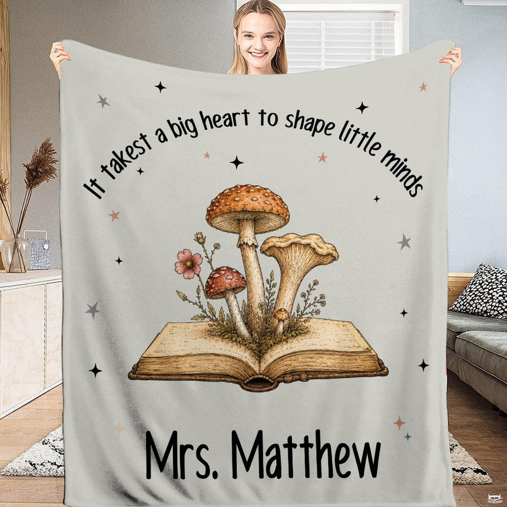 Vintage botanical bedding showing open book artwork with mushrooms, wildflowers, and celestial stars.