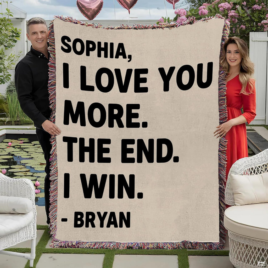 Couple holding romantic typography throw blanket with playful love message and colorful fringed edges