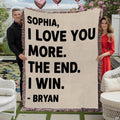 Couple holding romantic typography throw blanket with playful love message and colorful fringed edges