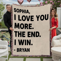Couple holding romantic typography throw blanket with playful love message and colorful fringed edges