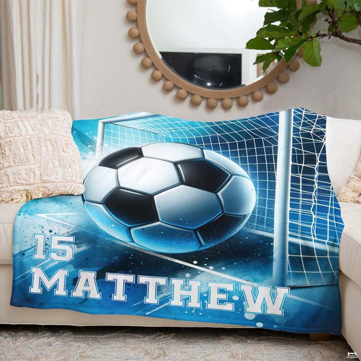 Living room couch arrangement highlighting the complete blue watercolor soccer graphic print.