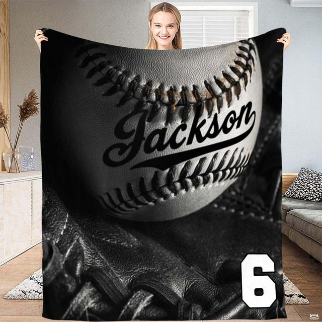 Monochrome studio still-life of a baseball inside a black fielder glove with dramatic lighting, view 2.