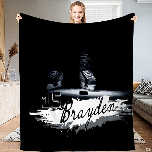 Ice hockey skates spotlight on rink graphic blanket held upright