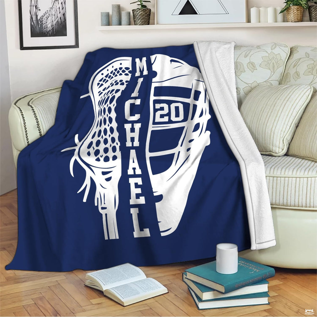 Graphic sports blanket draped across living room seating near a stack of books.