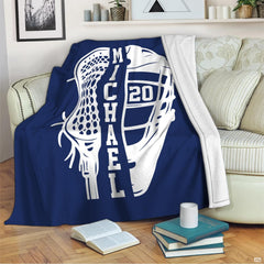 Graphic sports blanket draped across living room seating near a stack of books.