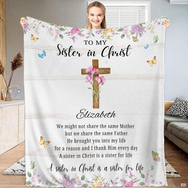 Christian faith throw blanket featuring a wooden cross with pink flowers, butterflies, and shiplap wood.