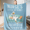 Resting nurse duck cartoon throw blanket featuring duck in scrubs on teal sofa against blue background