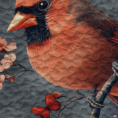 Close-up perspective of cardinal bedding highlighting scarlet red bird plumage, pine needles, and frosted boughs