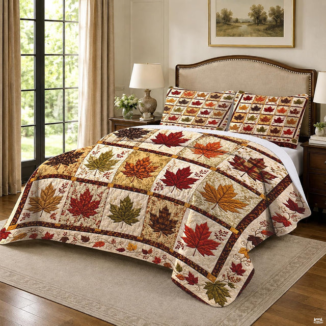 Close-up of crimson and plaid maple leaf blocks on a seasonal autumn bedding set
