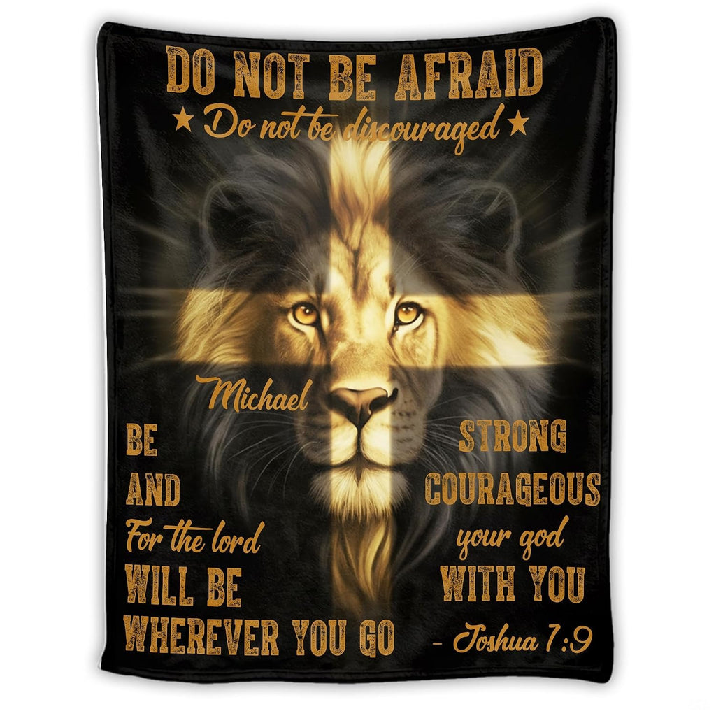 Graphic print featuring an expressive lion face illuminated by a shining golden cross on black.