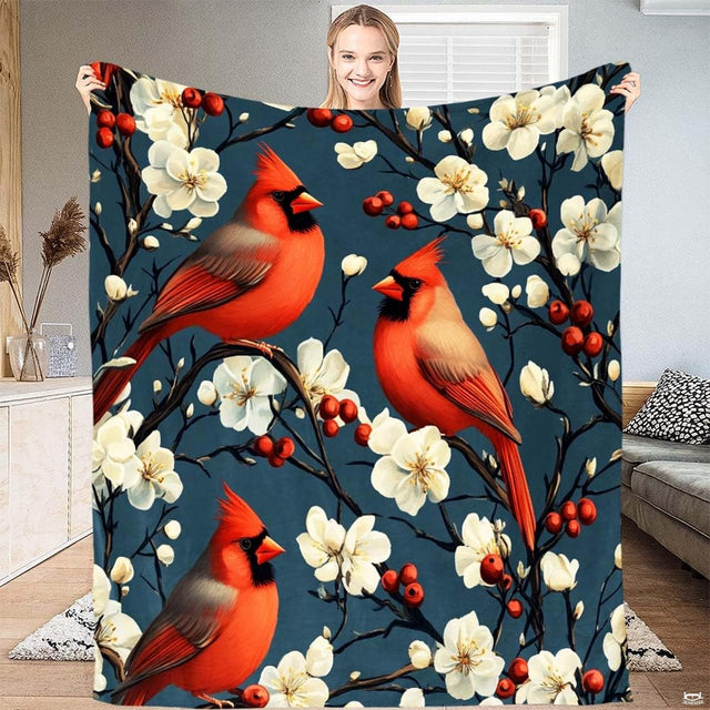 Full view of red cardinals botanical branch blanket held up indoors.