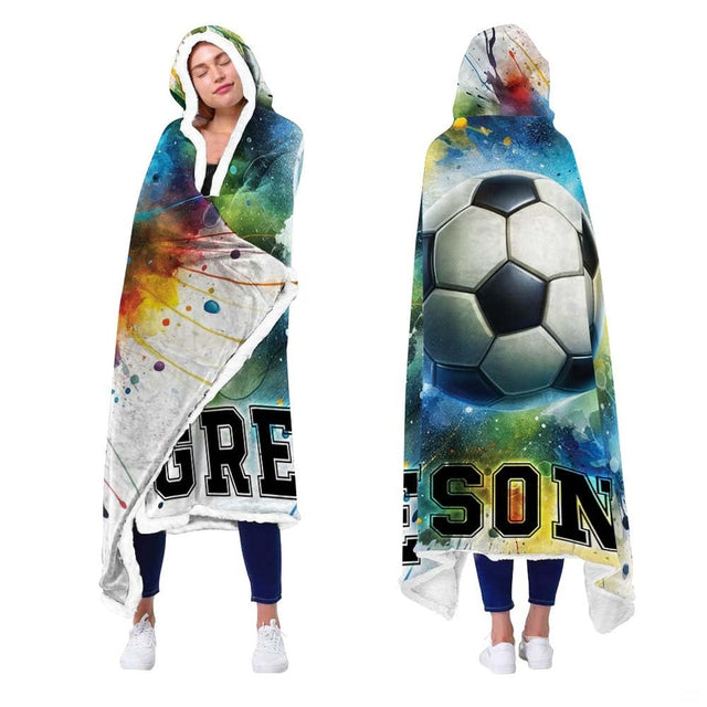 Person showcasing soccer blanket with vibrant multi-colored paint splash design