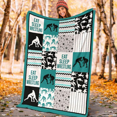 Close up view of wrestler silhouette blocks, star patterns, and teal chevron stripes.