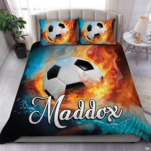 Fire and water soccer sports bedding featuring a soccer ball between splashing water and flames on a bed