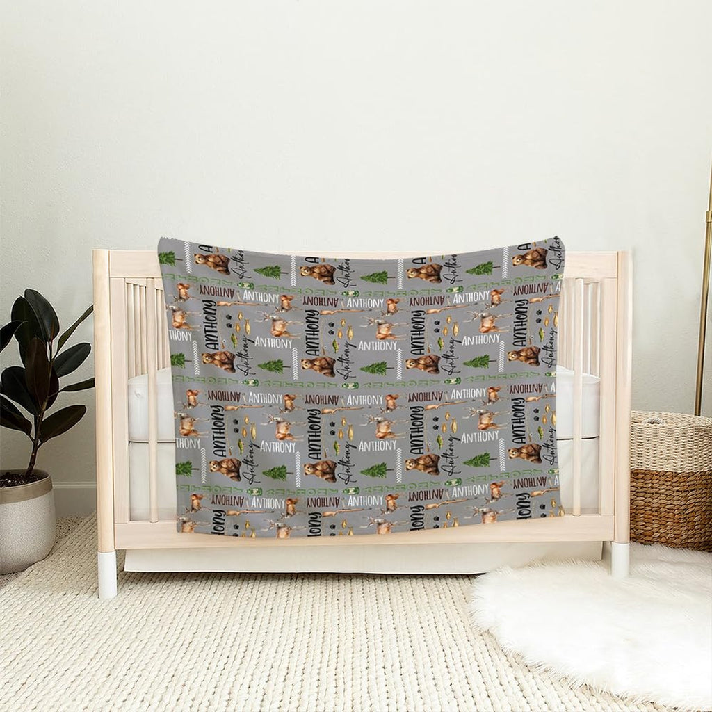 Close view of illustrated deer antlers, paw prints, and vintage camping lanterns on rustic lodge bedding.