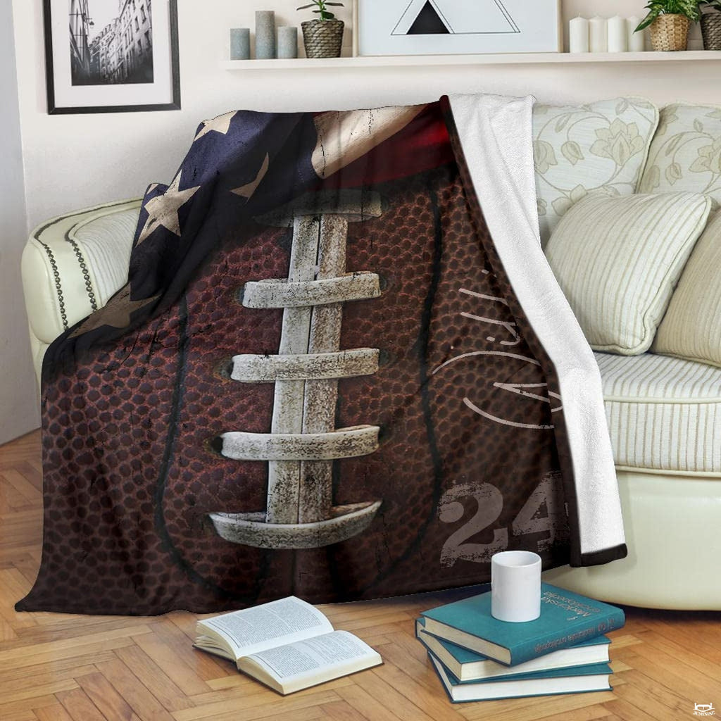 Rustic football graphic blanket styled across bedroom bed