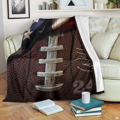 Rustic football graphic blanket styled across bedroom bed