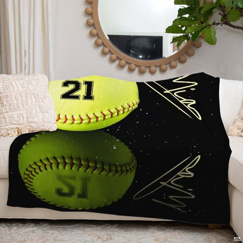 Softball throw blanket laid across white sofa beneath round wall mirror in living room