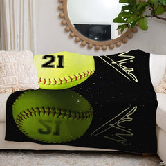 Softball throw blanket laid across white sofa beneath round wall mirror in living room