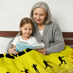 Athletic yellow softball player graphic blanket draped across bedroom bed
