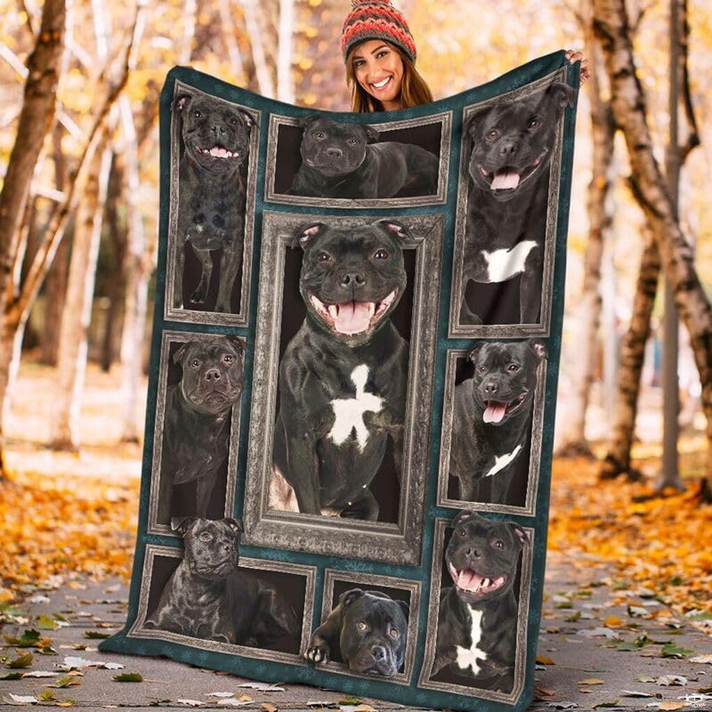 Model displaying the rectangular Staffordshire Bull Terrier portrait blanket outdoors in an autumn park.