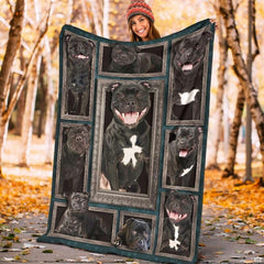 Model displaying the rectangular Staffordshire Bull Terrier portrait blanket outdoors in an autumn park.