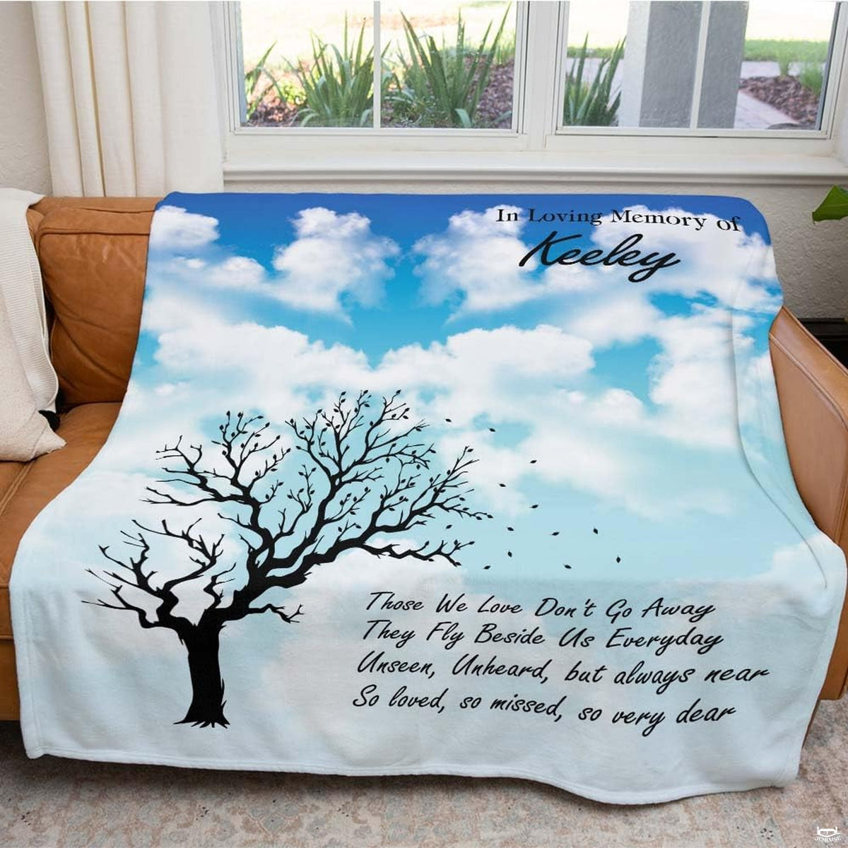 Outdoor bed setup artistic motif showcasing dramatic branch silhouettes over peaceful azure gradient hues.