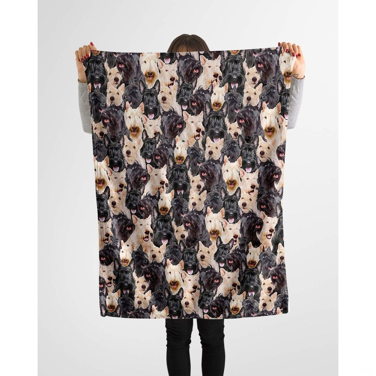 Scottish Terrier photo collage blanket styled across a couch in a room.