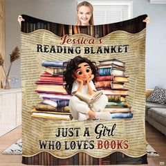 Person holding open the newsprint book blanket displaying the reader girl between book stacks and newsprint text.