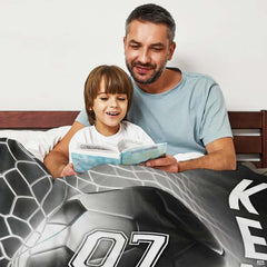 Monochrome soccer goal textile draped across living room sofa