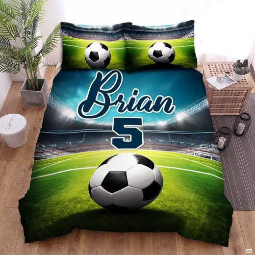 Electric turquoise and charcoal soccer sports bedding featuring a soccer ball graphic with cyan streaks on a bed