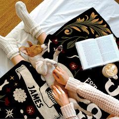 Full flat lay of the gothic floral skulls serpent romantic blanket composition.