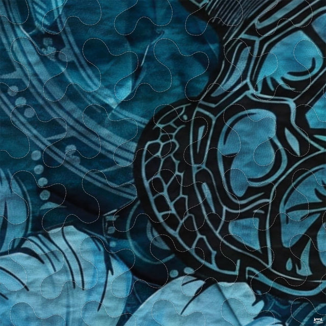 Close-up view of turtle bedding showcasing intricate Polynesian tribal motifs and ocean cyan tones