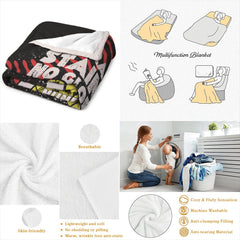 Neatly folded motivational softball throw blanket displayed on wooden surface showcasing clean edge borders