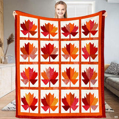 Close-up perspective of faceted geometric maple leaf silhouette in segmented crimson and terracotta tones