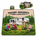 Family camping around a campfire in front of an RV with mountain background, view 1.