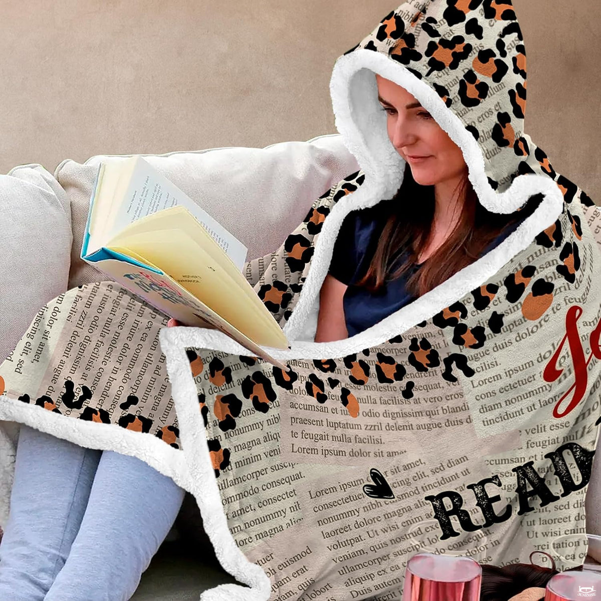 Artistic angle of whimsical book bedding with vintage newspaper collage print.