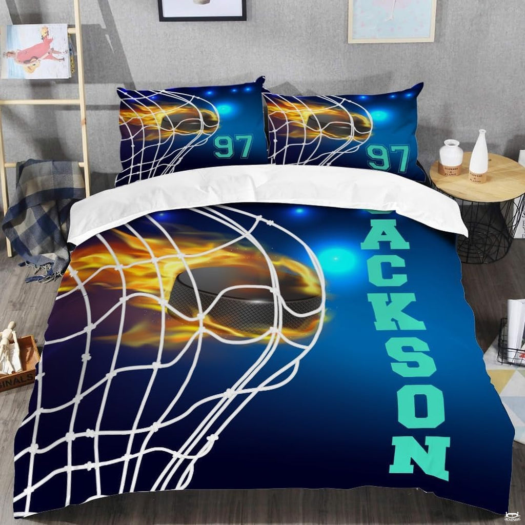 Top-down view of fire and ice hockey puck bedding set arranged neatly on a youth bedroom mattress