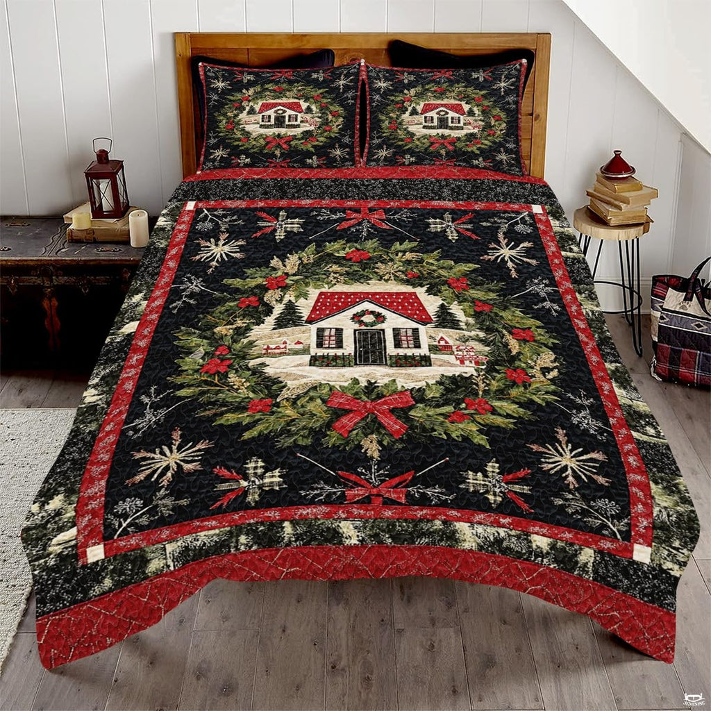 Winter cottage bedding set showcasing an illustrated snow-covered house inside an evergreen wreath with red bows.