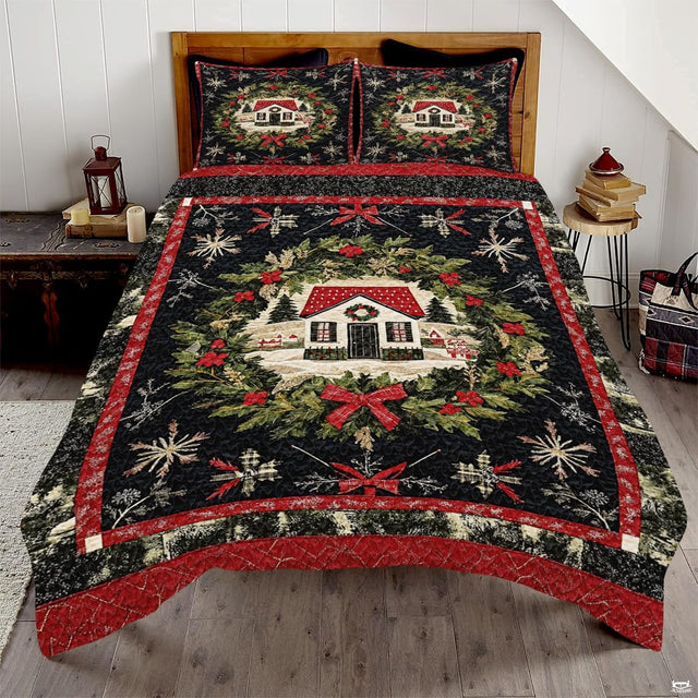 Winter cottage bedding set showcasing an illustrated snow-covered house inside an evergreen wreath with red bows.