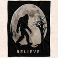 Bigfoot silhouette walking under thematic accent moon and spooky bare branches in cryptid room decor theme