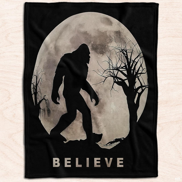 Bigfoot silhouette walking under thematic accent moon and spooky bare branches in cryptid room decor theme