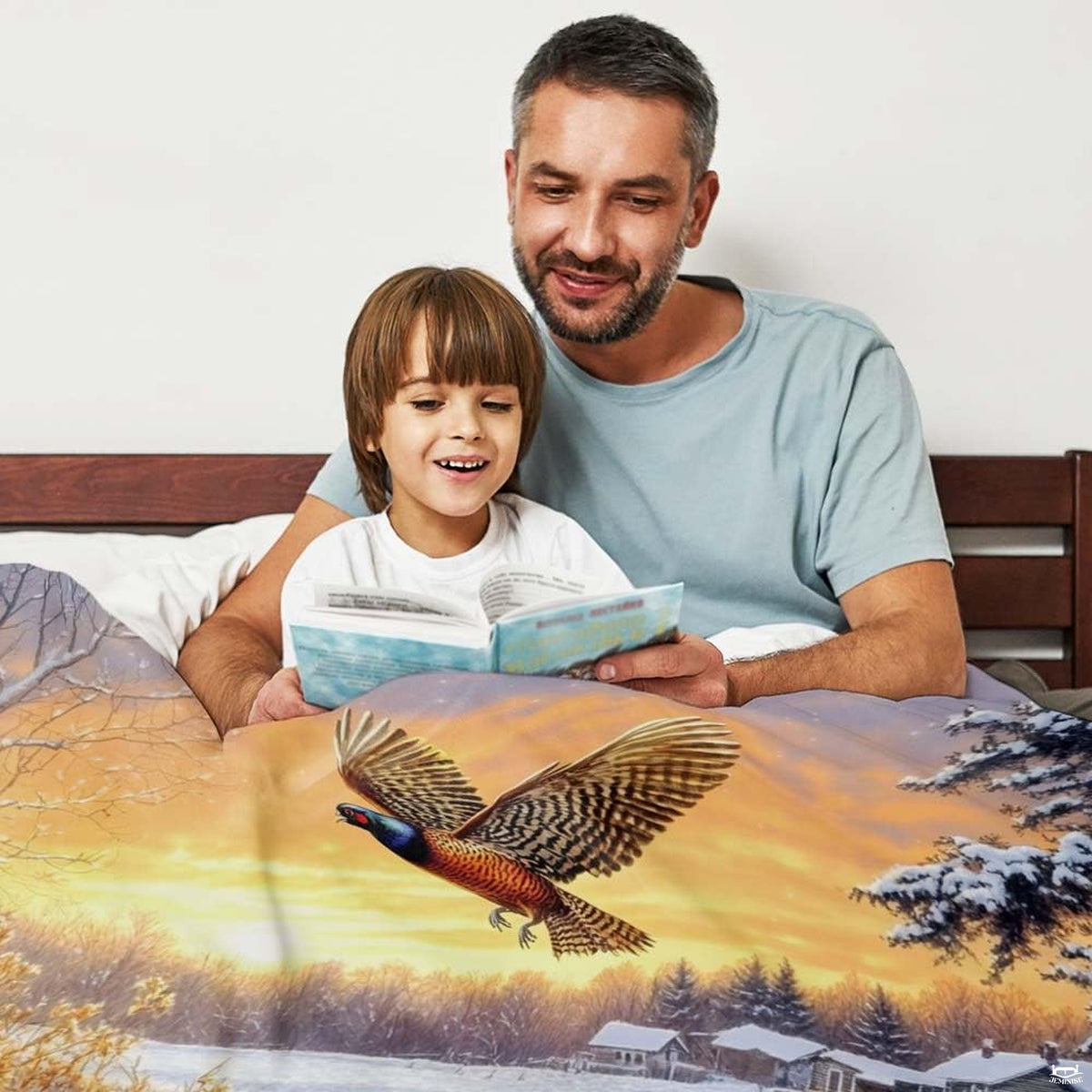 Scenic winter wildlife artwork on bedding showing a flying pheasant and hound near snowbound cabins.