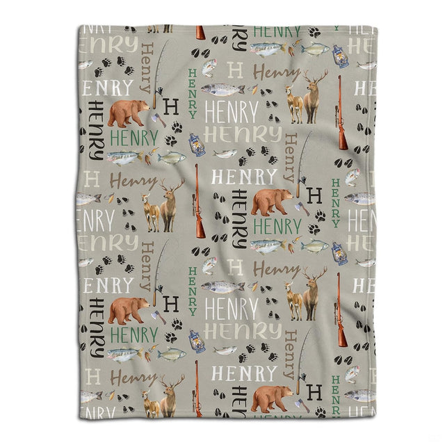 Flat lay display of outdoor pattern showing illustrated bears, deer, fish, rifles, and fishing rods on taupe.