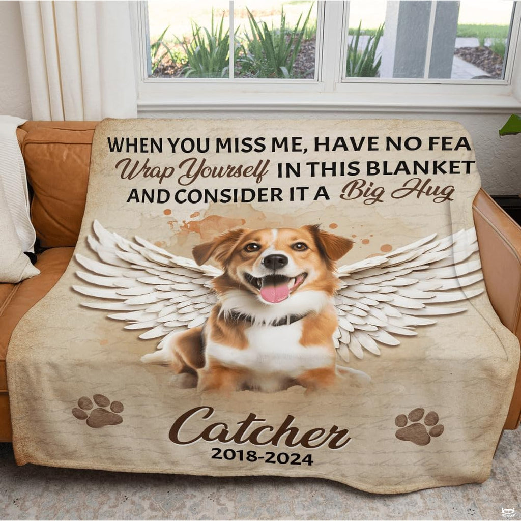 Folded pet remembrance blanket resting on a rustic wooden bench
