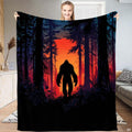 Sunset Bigfoot silhouette throw blanket showing Sasquatch among pine trees backlit by glowing red sunset